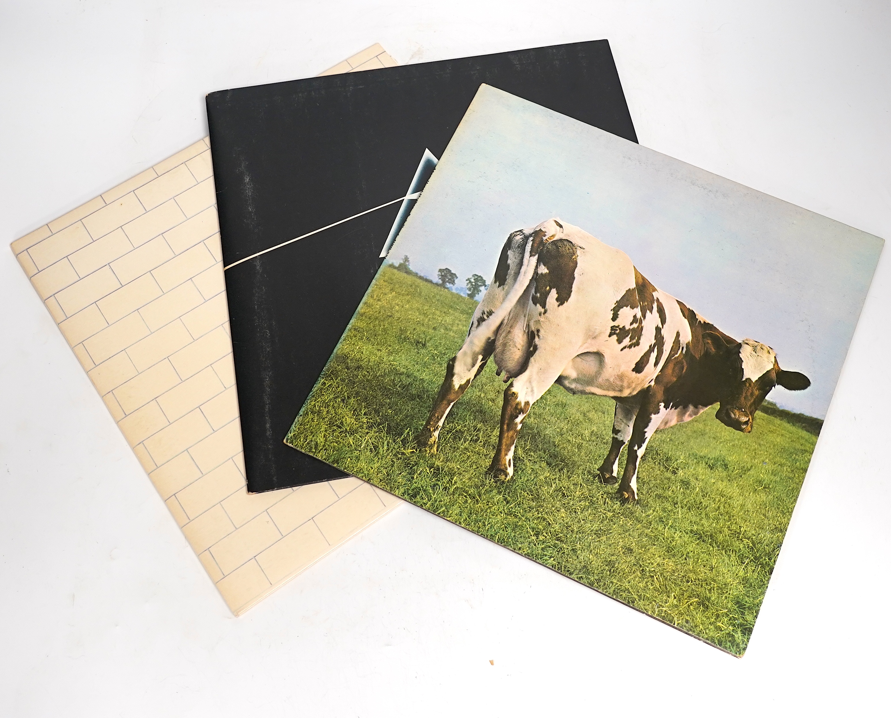 Three Pink Floyd LP record albums; The Wall, SHDW 4111, Dark Side of the Moon, SHVL804, with both posters and two postcards, Atom Heart Mother, SHVL781